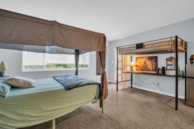 bedroom featuring stainless steel refrigerator