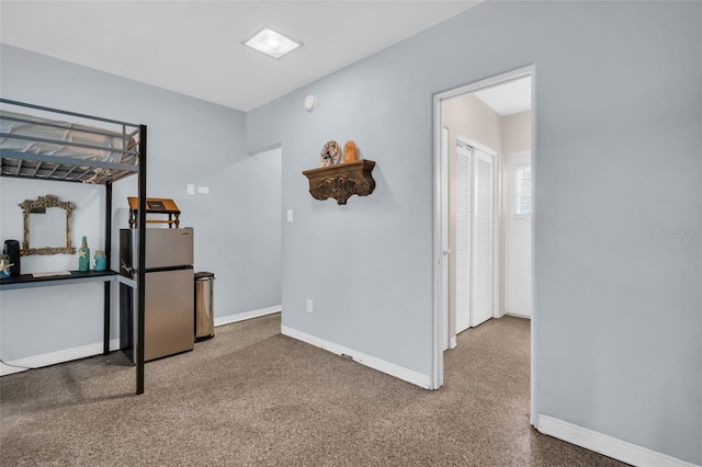 bedroom featuring stainless steel refrigerator