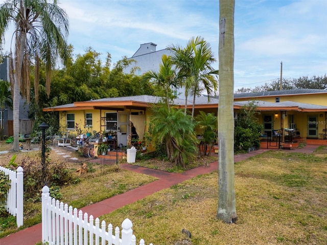 view of front of house featuring a front lawn and a patio