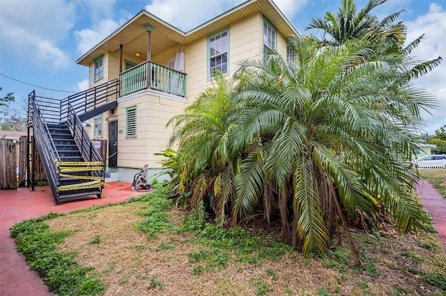 back of house featuring a balcony