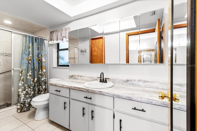 bathroom featuring tile patterned floors, vanity, toilet, and walk in shower