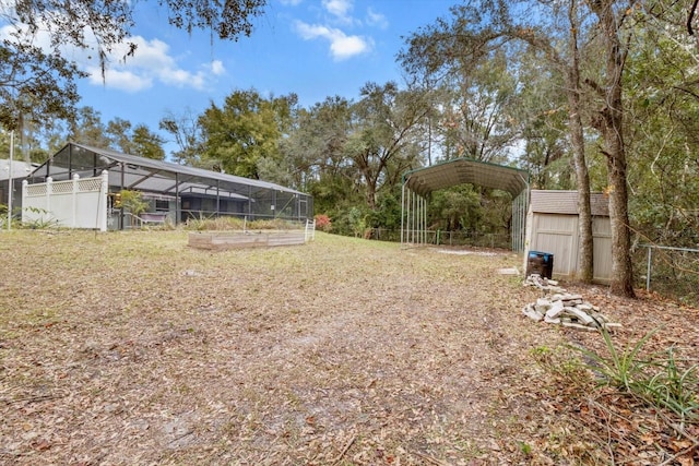 view of yard featuring a lanai and a shed