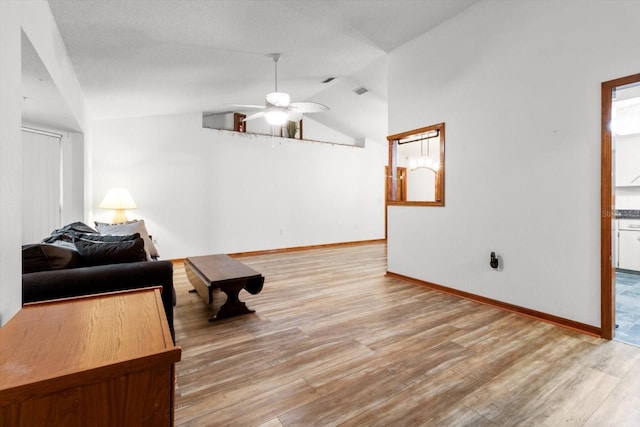 sitting room featuring ceiling fan, lofted ceiling, and light wood-type flooring