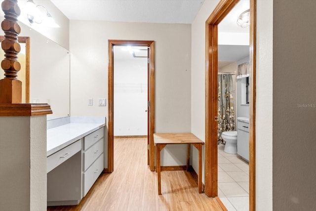 bathroom featuring vanity, toilet, wood-type flooring, and a textured ceiling