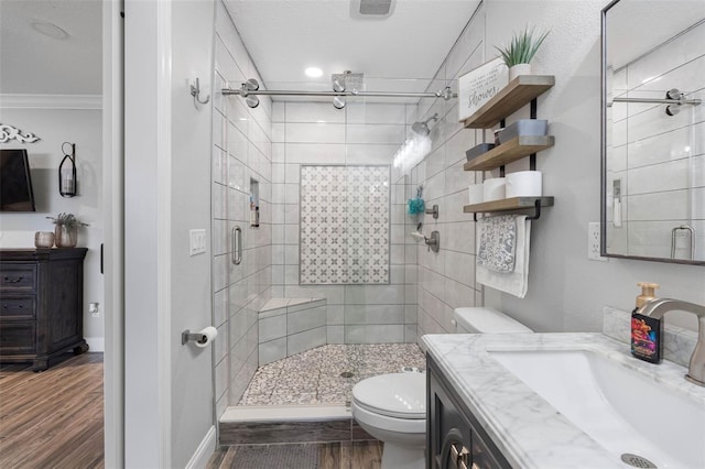 bathroom with toilet, an enclosed shower, vanity, and crown molding