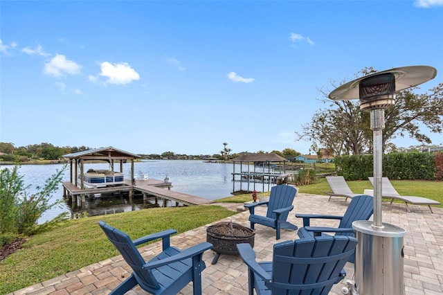 view of patio featuring an outdoor fire pit, a boat dock, and a water view