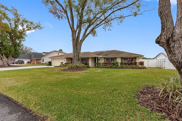 single story home featuring a front lawn and a garage