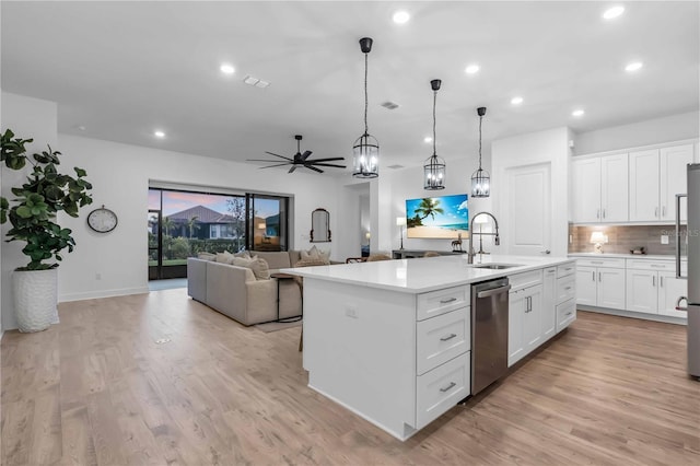 kitchen featuring light hardwood / wood-style floors, a kitchen island with sink, stainless steel dishwasher, sink, and white cabinets