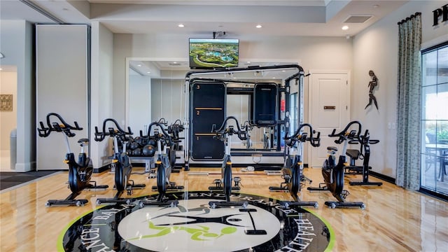 exercise room with a tray ceiling