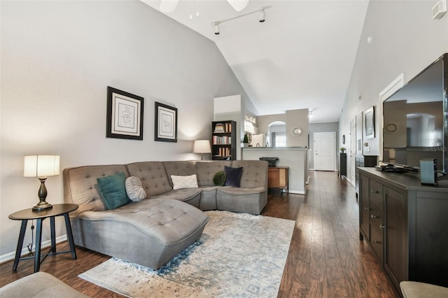 living room featuring ceiling fan, dark hardwood / wood-style floors, high vaulted ceiling, and rail lighting