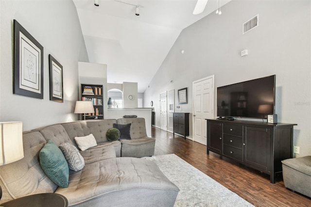 living room with track lighting, high vaulted ceiling, dark hardwood / wood-style floors, and ceiling fan