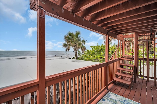 deck with a water view and a beach view