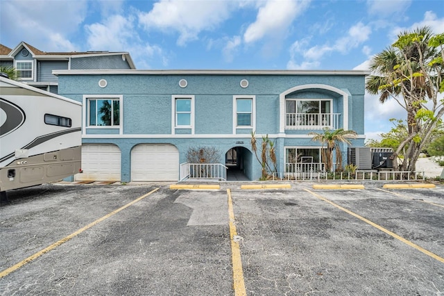 view of property with a garage and a balcony