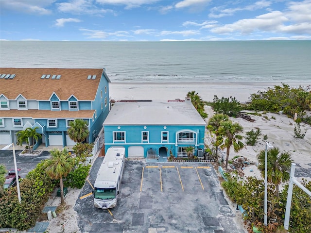 aerial view with a water view and a beach view