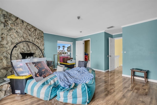 bedroom with wood-type flooring and crown molding