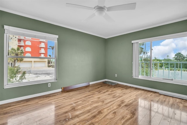 spare room with ceiling fan, ornamental molding, and light hardwood / wood-style floors