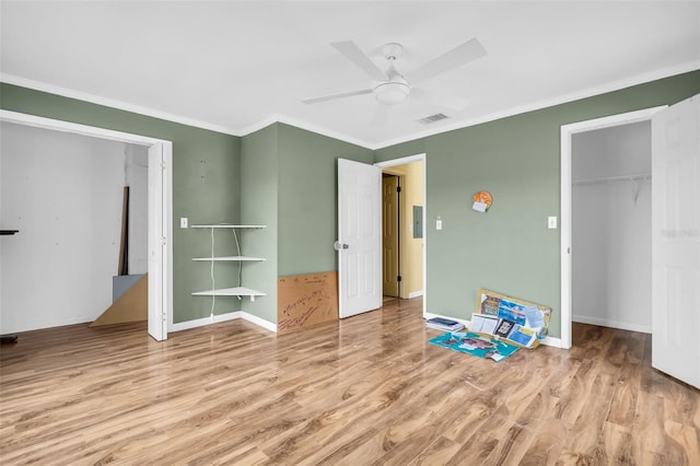 unfurnished bedroom with ceiling fan, a closet, crown molding, and light hardwood / wood-style floors