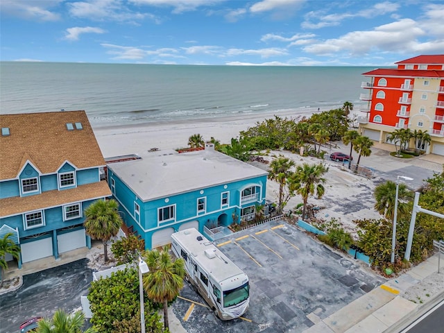 drone / aerial view featuring a water view and a view of the beach