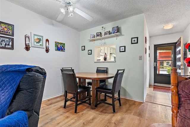 dining room featuring a textured ceiling, ceiling fan, and light hardwood / wood-style floors