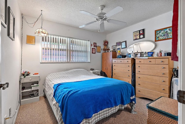 bedroom featuring ceiling fan, light carpet, and a textured ceiling