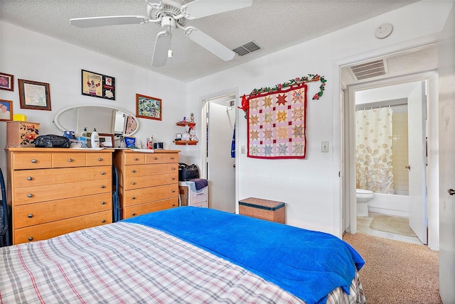 bedroom featuring a textured ceiling, ceiling fan, connected bathroom, and carpet floors