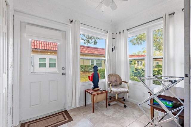 sunroom featuring ceiling fan and a wealth of natural light