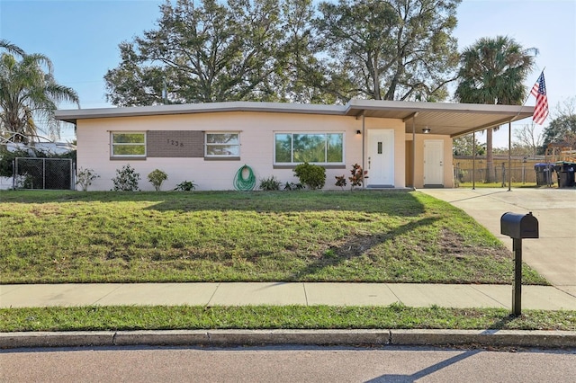 view of front of house with a front yard and a carport