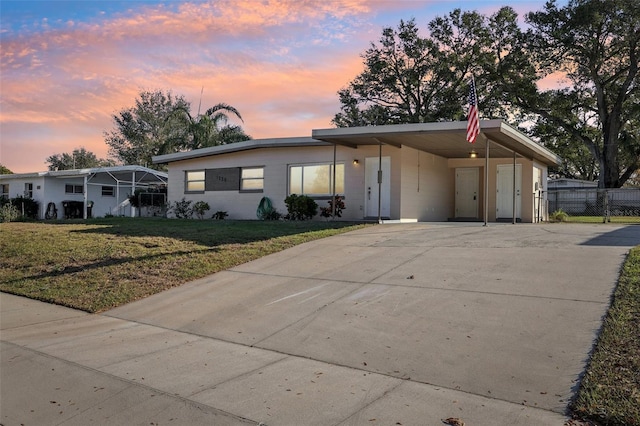 view of front facade with a yard and a carport