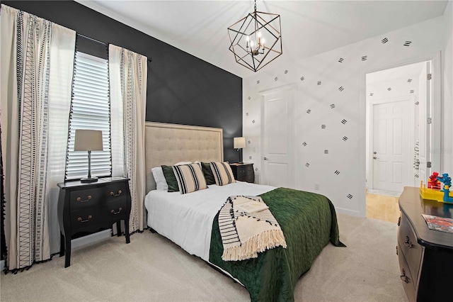 carpeted bedroom with a chandelier and ensuite bathroom