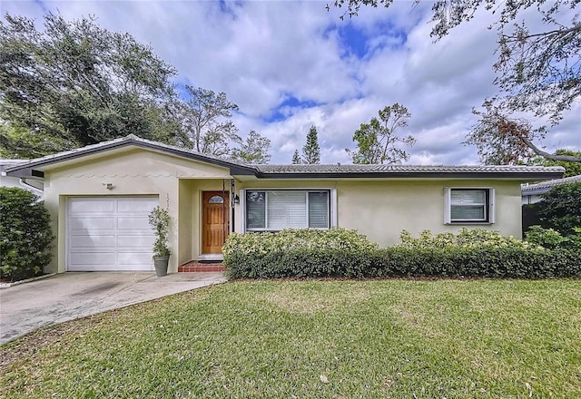 ranch-style home with a front yard and a garage