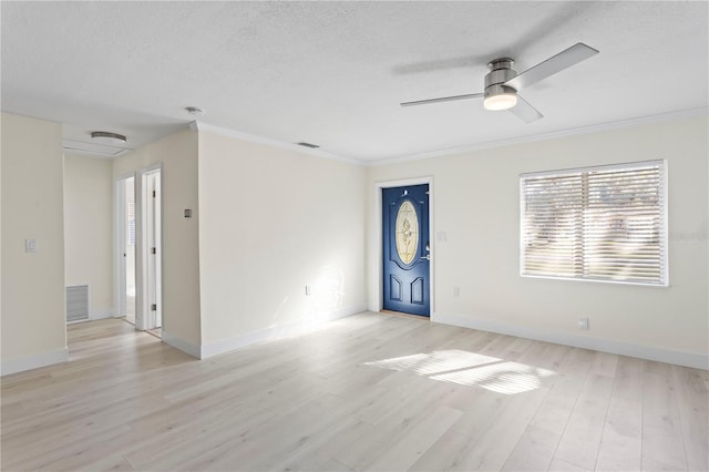 unfurnished room featuring crown molding, light hardwood / wood-style flooring, a textured ceiling, and ceiling fan