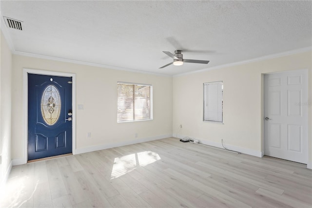 foyer featuring crown molding, ceiling fan, light hardwood / wood-style floors, and a textured ceiling