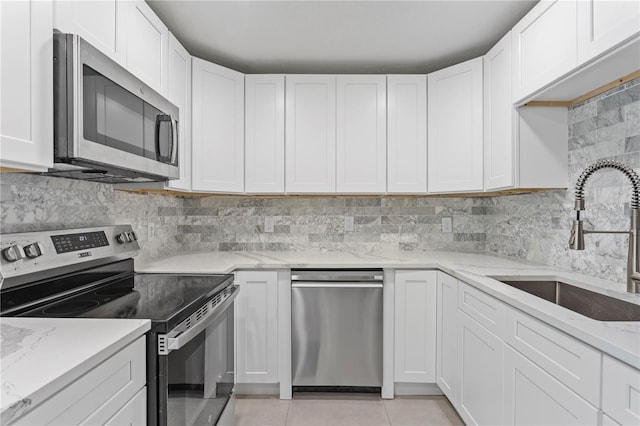 kitchen featuring white cabinetry, appliances with stainless steel finishes, and sink