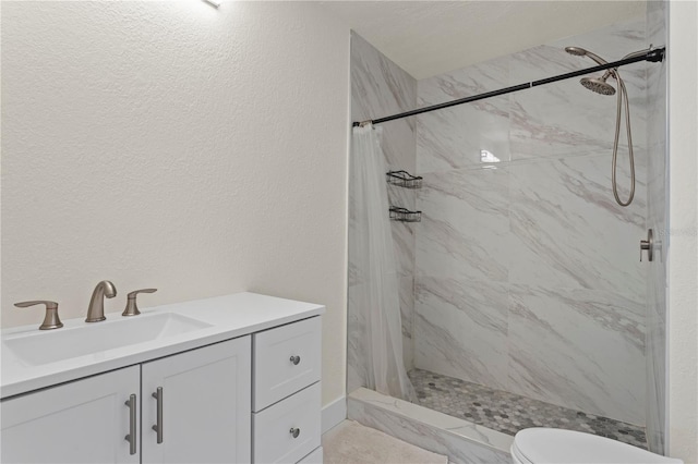 bathroom featuring walk in shower, vanity, and toilet