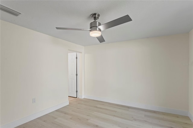 spare room with ceiling fan, a textured ceiling, and light wood-type flooring