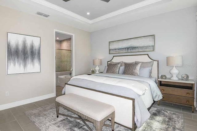 bedroom featuring ceiling fan, a raised ceiling, dark tile patterned floors, and connected bathroom