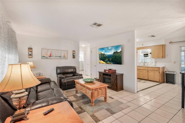 living room with sink and light tile patterned floors