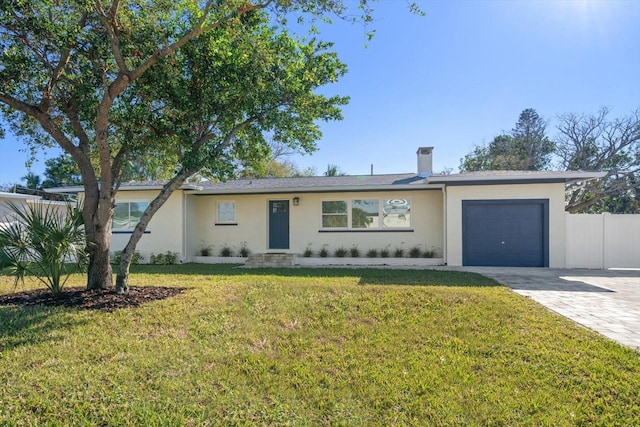 ranch-style house featuring a front lawn and a garage