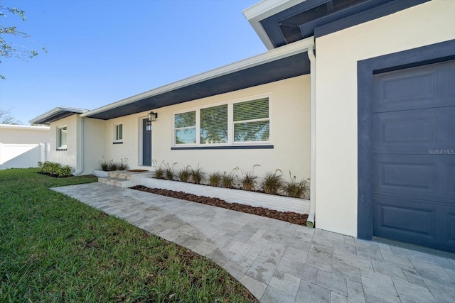 exterior space with a garage and a front lawn