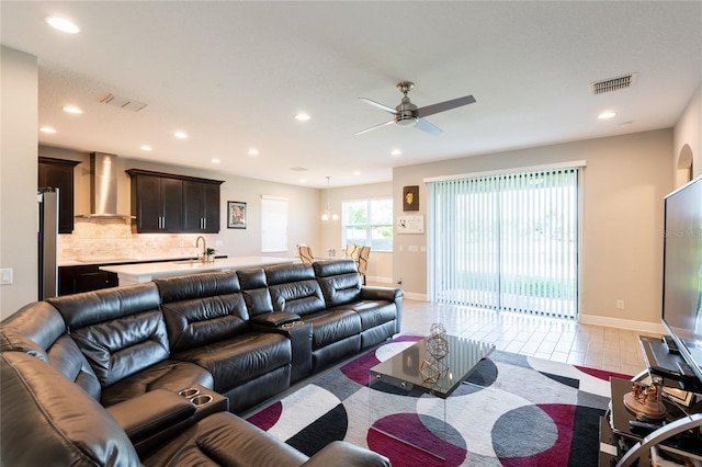 living room featuring ceiling fan and sink