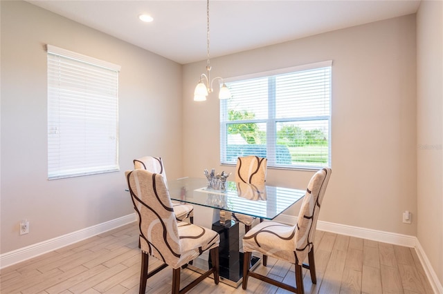 dining room featuring light hardwood / wood-style floors, a wealth of natural light, and a chandelier