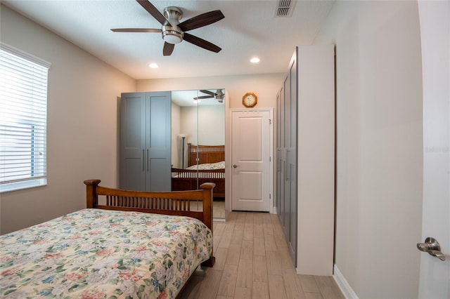 bedroom featuring ceiling fan and light hardwood / wood-style floors