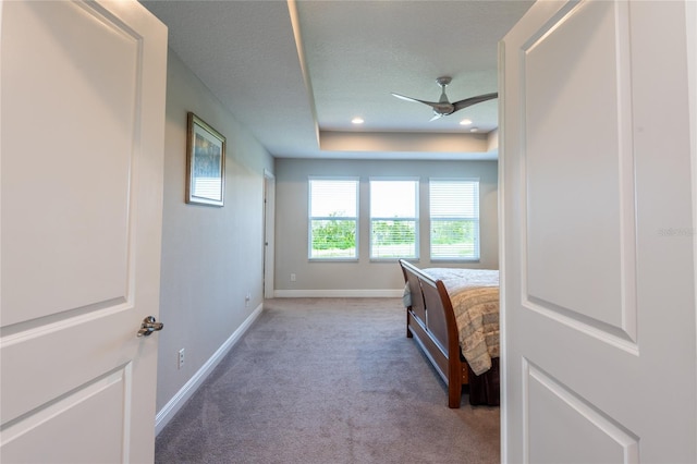 bedroom featuring ceiling fan, carpet floors, and a textured ceiling