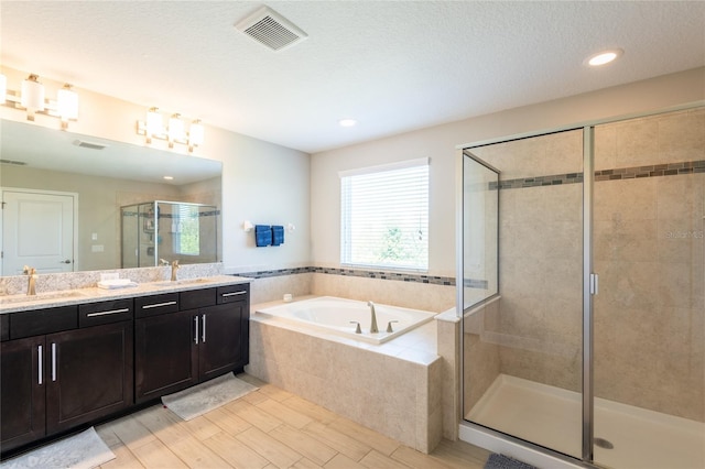 bathroom featuring vanity and independent shower and bath