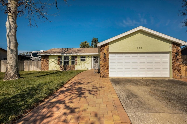 ranch-style house with a garage and a front lawn