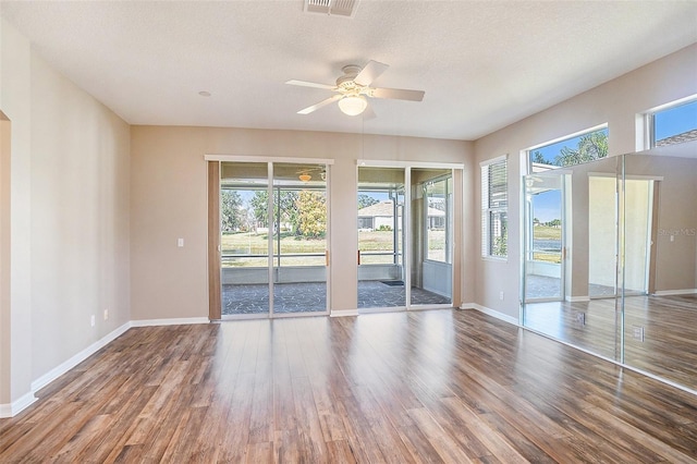 empty room featuring a textured ceiling, ceiling fan, and hardwood / wood-style flooring