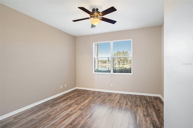 spare room with dark hardwood / wood-style flooring, a textured ceiling, and ceiling fan