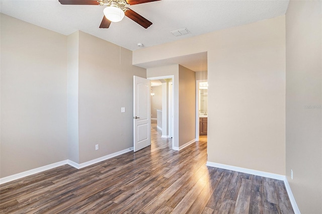 spare room featuring ceiling fan and dark hardwood / wood-style floors