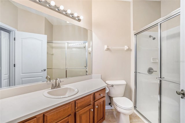 bathroom featuring tile patterned floors, an enclosed shower, vanity, and toilet