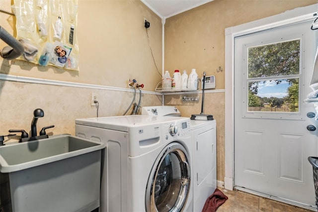 laundry area featuring sink and separate washer and dryer